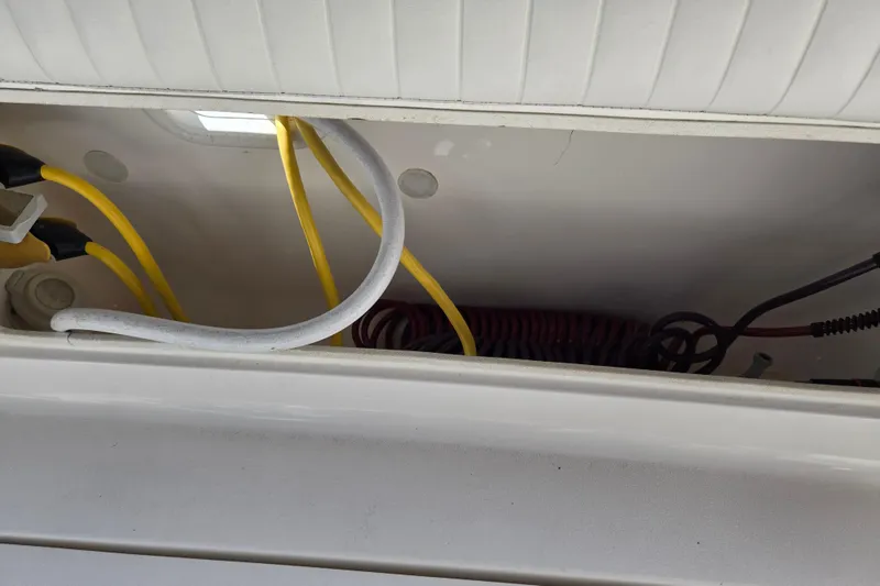 Slide: The Image of 2002 Silverton 351 Sedan Cruiser electrical compartment with yellow and white cables. - 29