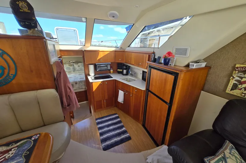 Slide: The Image of Interior of 2002 Silverton 351 Sedan Cruiser with kitchenette and seating area. - 8