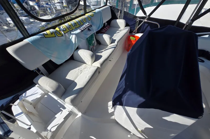 Slide: The Image of 2002 Silverton 351 Sedan Cruiser interior with white seating and nautical decor. - 9