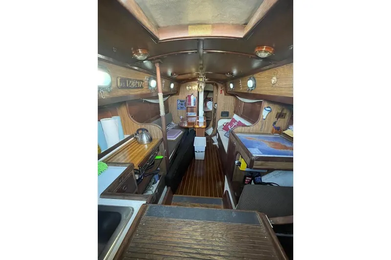 Slide: The Image of Interior of 1977 Custom Bodega 30 sailboat with wooden finishes and nautical decor. - 19