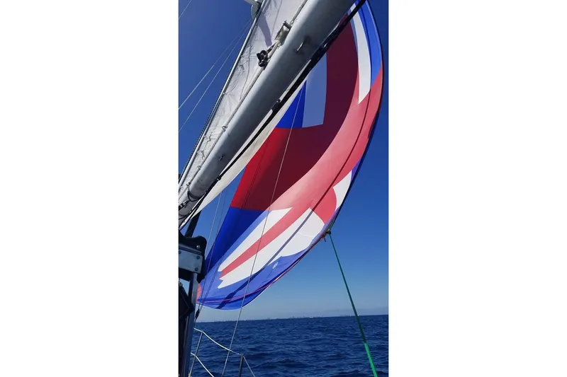Slide: The Image of Sailboat with colorful spinnaker on open sea, Custom Bodega 30, 1977 model. - 25