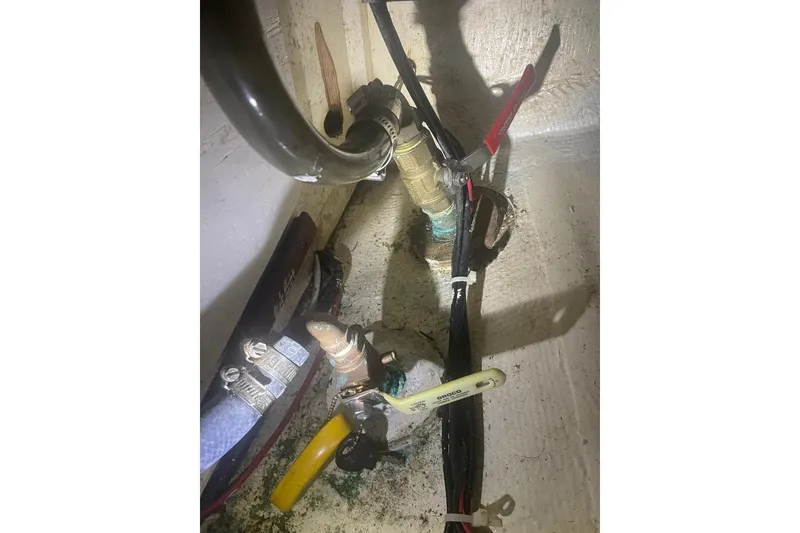 Slide: The Image of Interior of 1977 Custom Bodega 30 showing plumbing and wiring components. - 51