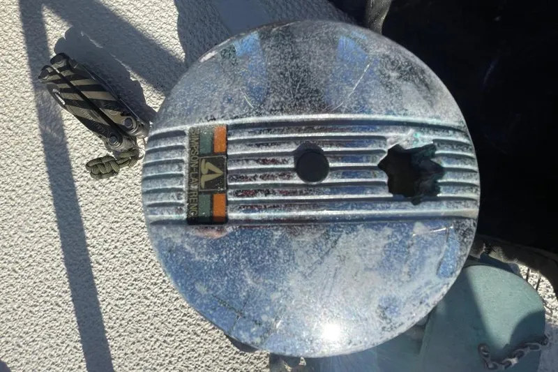 Slide: The Image of Damaged piston from a 1977 Custom Bodega 30 engine, showcasing wear and tear. - 6