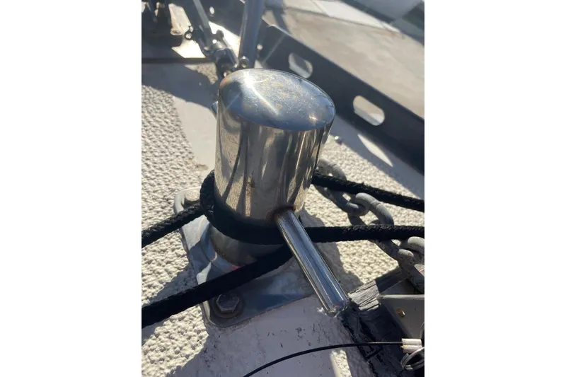 Slide: The Image of Stainless steel cleat on 1977 Custom Bodega 30 boat deck with ropes and chains. - 7