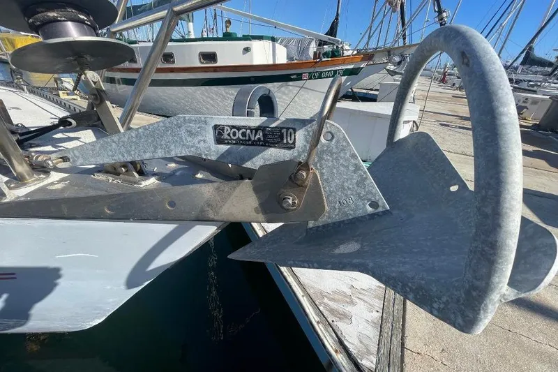 Slide: The Image of Rocna anchor on Custom Bodega 30 sailboat, 1977 model, docked at marina. - 8