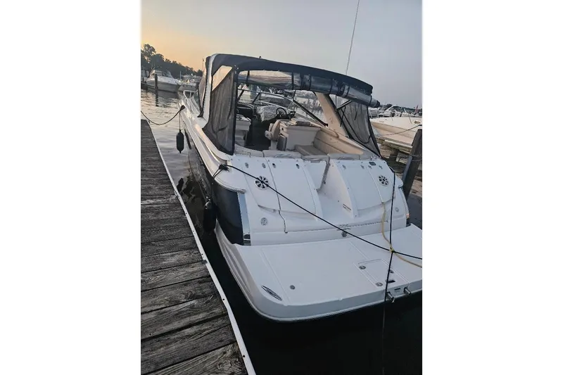 The Image of 2010 Regal 3350 Cuddy boat docked at marina during sunset. - 0