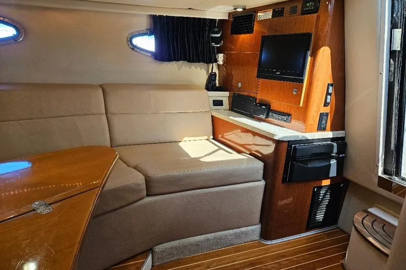 Slide: The Image of Interior of 2010 Regal 3350 Cuddy boat with cozy seating and entertainment system. - 5