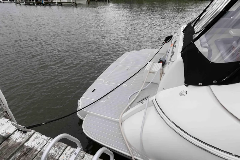 Slide: The Image of 2007 Cruisers Yachts 460 Express docked, showcasing rear deck and water view. - 11