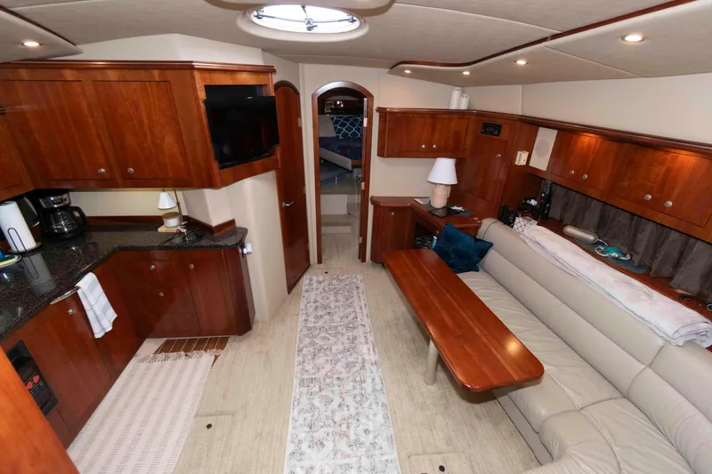 Slide: The Image of Luxurious interior of 2007 Cruisers Yachts 460 Express with elegant wood cabinetry and cozy seating. - 12