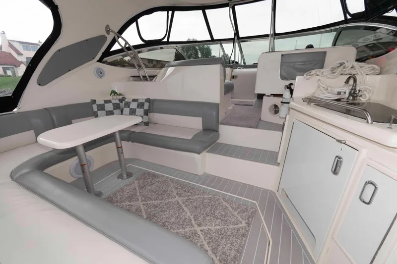 Slide: The Image of 2007 Cruisers Yachts 460 Express interior with seating, table, and kitchenette. - 2
