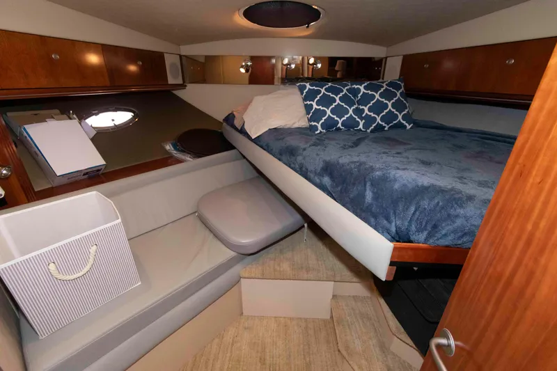 Slide: The Image of 2007 Cruisers Yachts 460 Express cabin with cozy bed and seating area. - 20