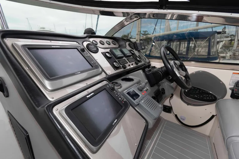 Slide: The Image of 2007 Cruisers Yachts 460 Express helm with advanced navigation systems and steering wheel. - 5