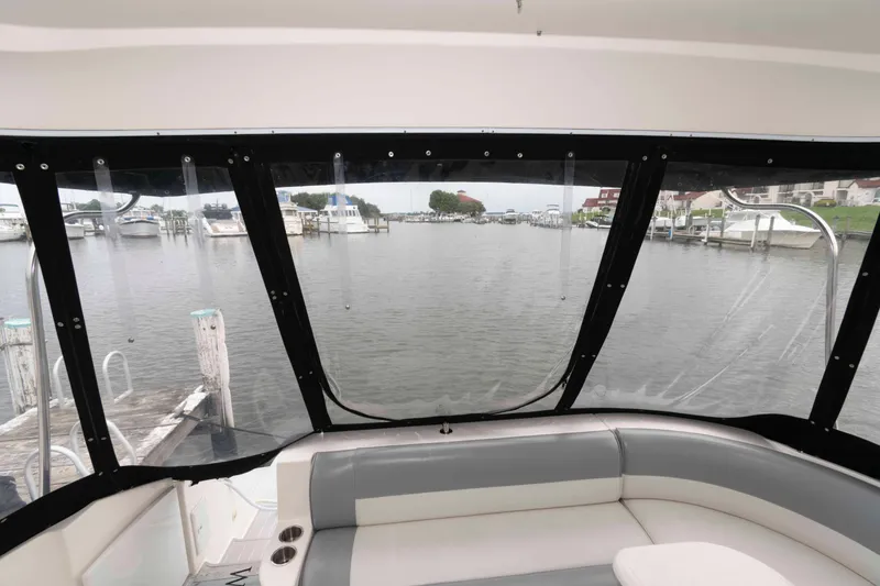 Slide: The Image of 2007 Cruisers Yachts 460 Express interior view overlooking marina through large windows. - 10