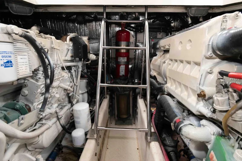 Slide: The Image of Engine room of 2007 Cruisers Yachts 460 Express, featuring mechanical components and fire extinguisher. - 22