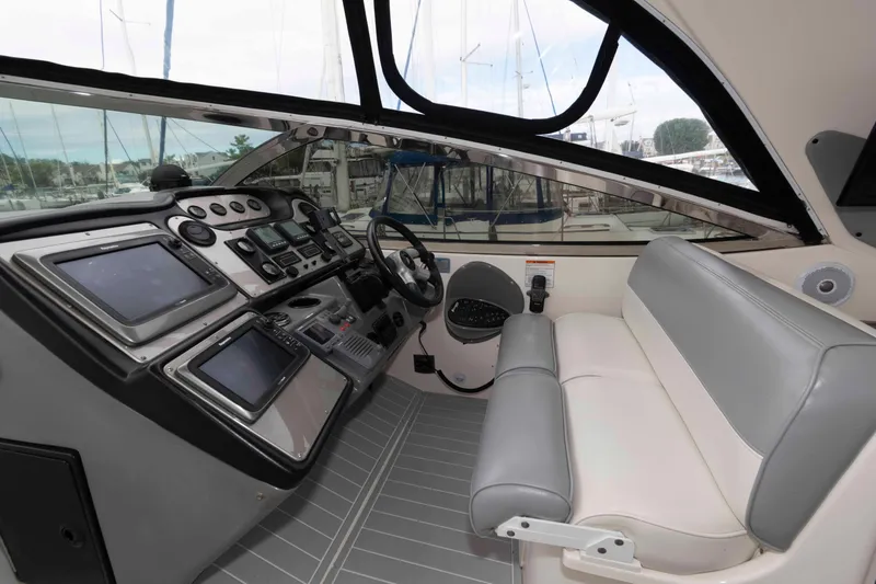 Slide: The Image of 2007 Cruisers Yachts 460 Express helm with modern navigation equipment and comfortable seating. - 4