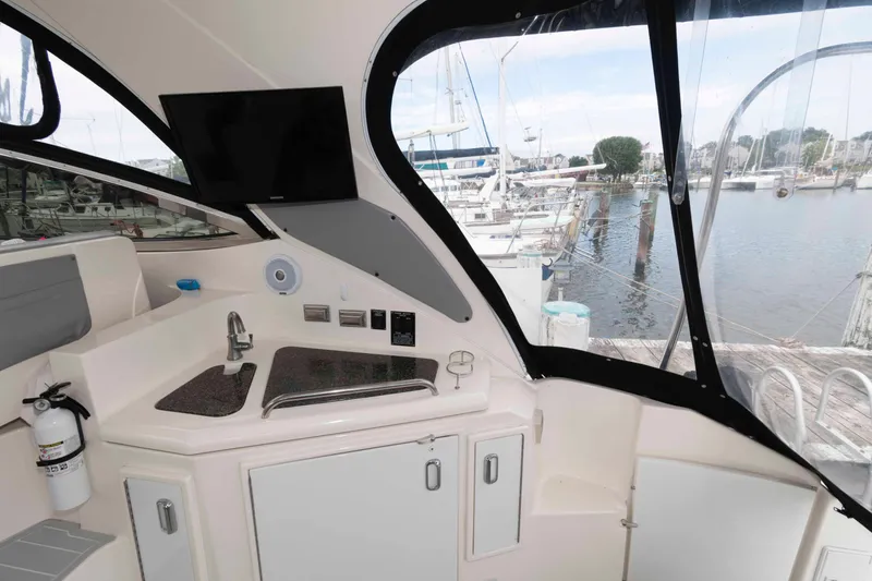 Slide: The Image of 2007 Cruisers Yachts 460 Express interior with kitchenette and marina view. - 9