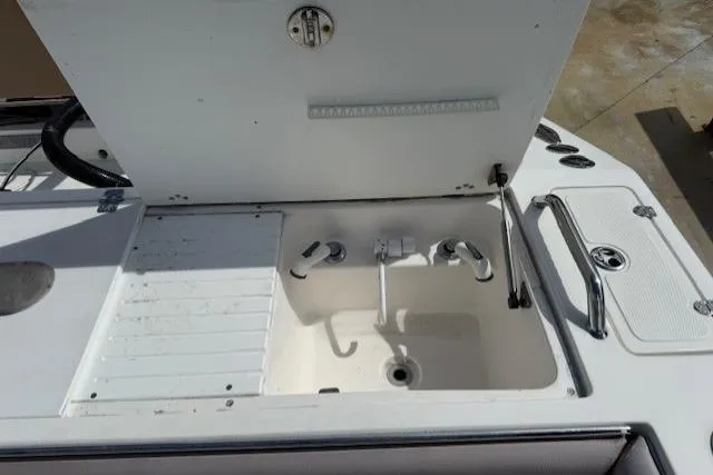 Slide: The Image of 2005 Dakota 36 CC Forward Cuddy Cabin boat sink and storage area. - 13