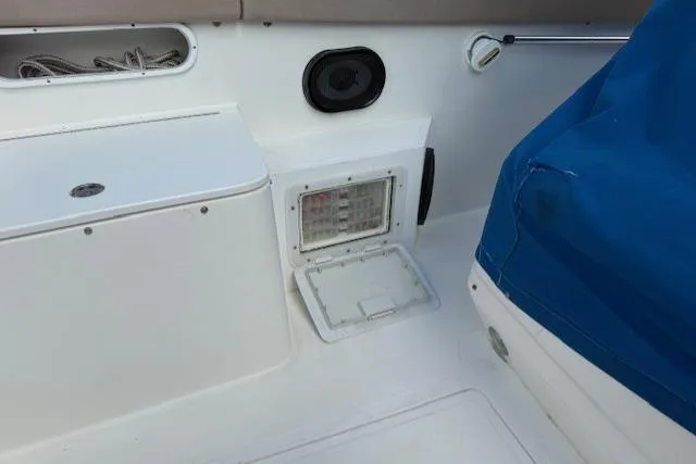 Slide: The Image of 2005 Dakota 36 CC Forward Cuddy Cabin interior with storage compartments and blue cover. - 20