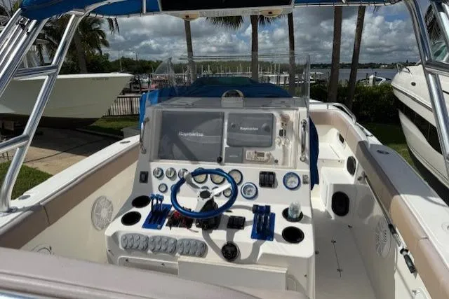 Slide: The Image of 2005 Dakota 36 CC Forward Cuddy Cabin boat cockpit with steering wheel and control panel. - 5