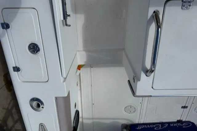 Slide: The Image of 2005 Dakota 36 CC Forward Cuddy Cabin interior with storage compartments and stainless steel handles. - 9