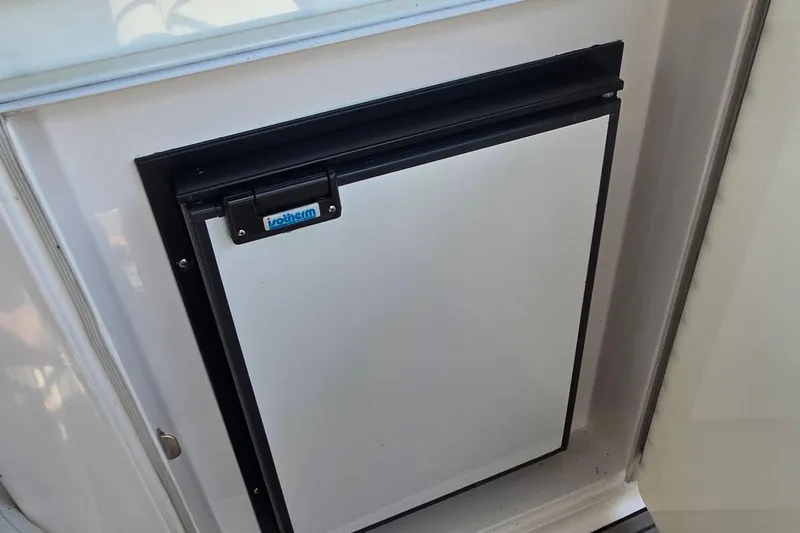 Slide: The Image of Interior of 2004 Regal Commodore 3260 boat with seating and table, docked at marina. - 11