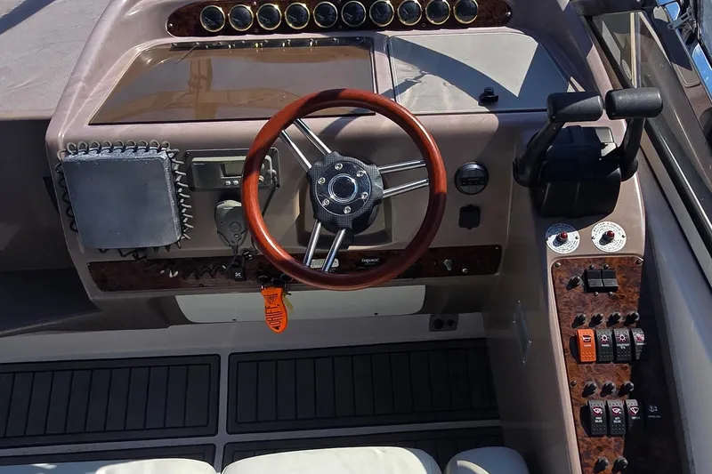 Slide: The Image of 2004 Regal Commodore 3260 boat interior with white seating, table, and sink. - 13