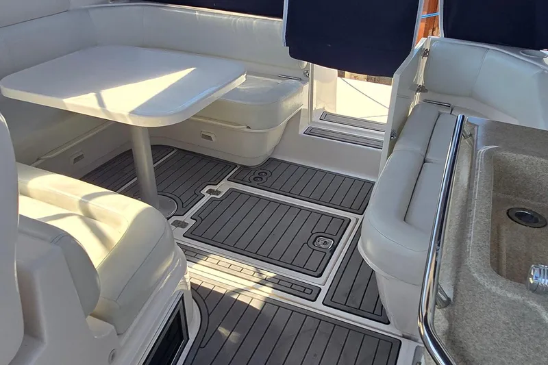 Slide: The Image of 2004 Regal Commodore 3260 boat dashboard with wood accents and control switches. - 14