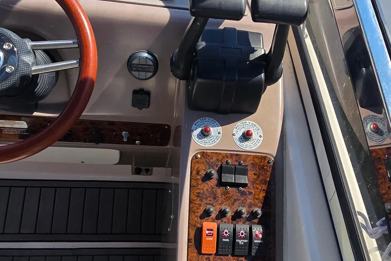 Slide: The Image of Dashboard of a 2004 Regal Commodore 3260 boat with multiple gauges and controls. - 15