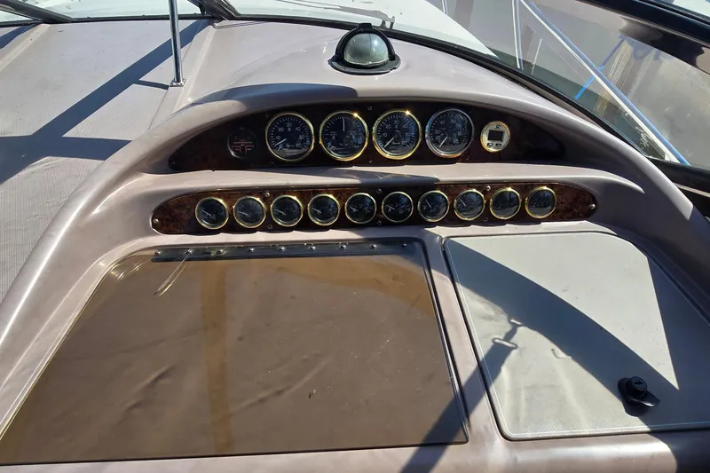 Slide: The Image of Storage compartment in a 2004 Regal Commodore 3260 boat with cleaning supplies and fire extinguisher. - 16