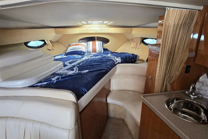 Slide: The Image of 2004 Regal Commodore 3260 interior with wooden cabinetry and white seating. - 18