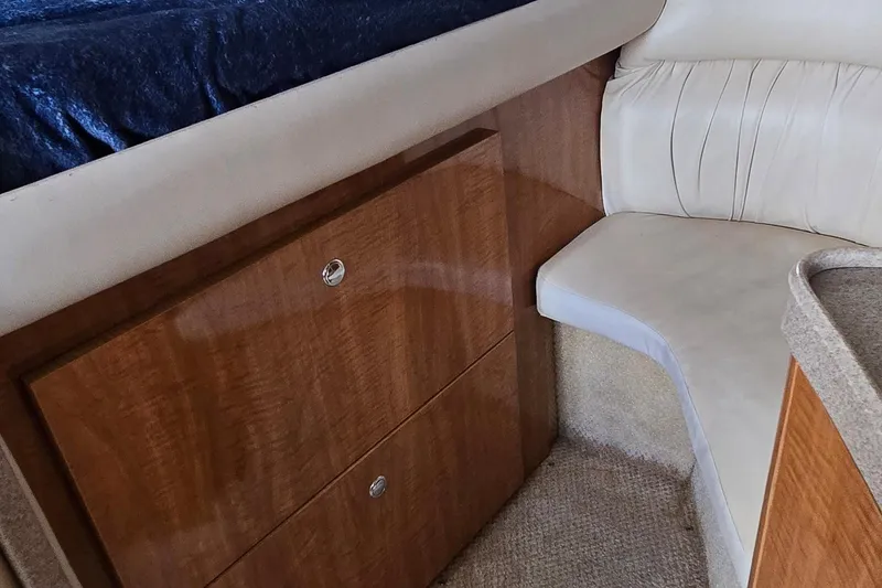 Slide: The Image of Interior of 2004 Regal Commodore 3260 yacht with beige seating and wooden accents. - 19
