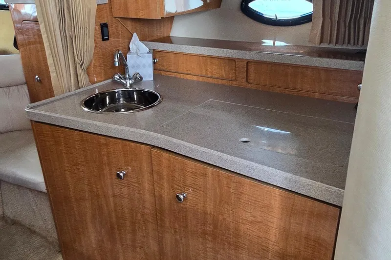 Slide: The Image of Interior cabin of 2004 Regal Commodore 3260 with anchor-patterned bedding and striped pillows. - 22