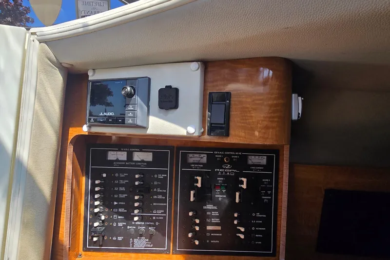 Slide: The Image of Wooden cabinet interior of 2004 Regal Commodore 3260 boat, featuring a hinge and document. - 25