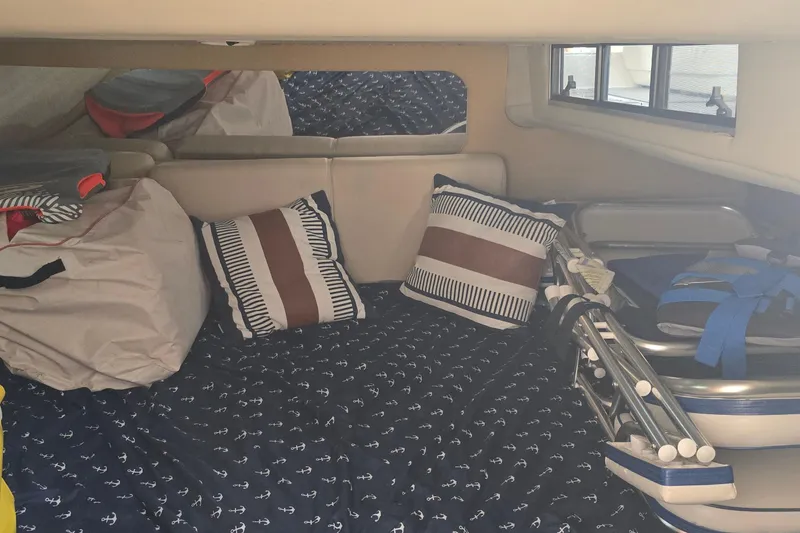 Slide: The Image of Interior of 2004 Regal Commodore 3260 yacht with beige seating and wooden accents. - 31