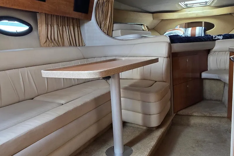 Slide: The Image of 2004 Regal Commodore 3260 interior with plush seating and kitchenette. - 32