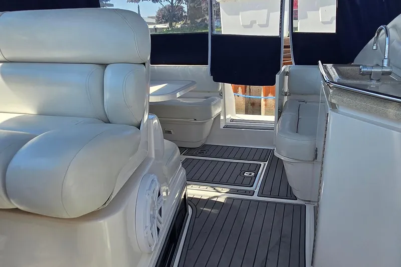 Slide: The Image of 2004 Regal Commodore 3260 boat cockpit view at marina, showcasing dashboard and steering wheel. - 33