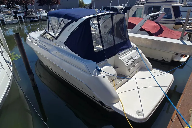 Slide: The Image of 2004 Regal Commodore 3260 boat named "Sticky Business" docked at marina. - 4