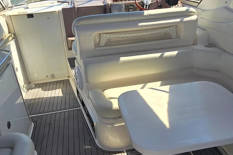 Slide: The Image of 2004 Regal Commodore 3260 yacht interior with white seating and compact sink area. - 8