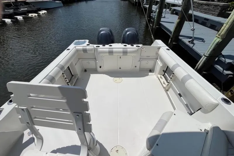 Slide: The Image of 2011 Sailfish 2660 WAC boat interior with seating, docked by the water. - 11