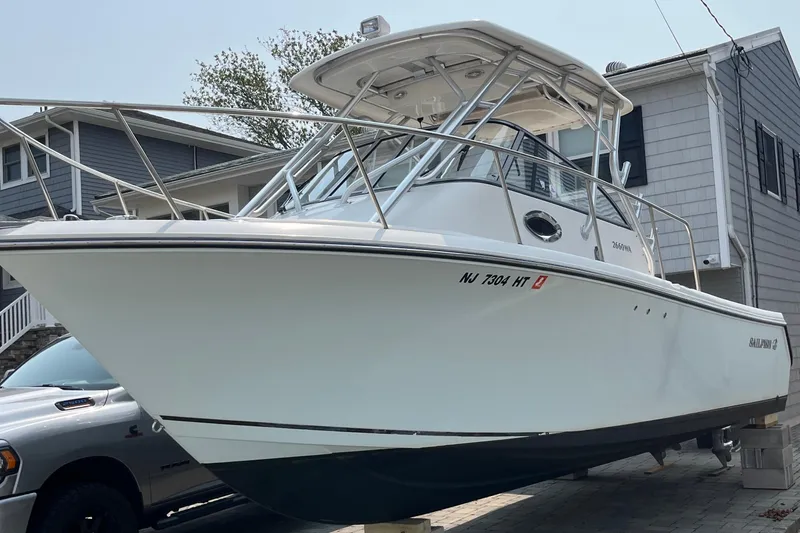 Slide: The Image of 2011 Sailfish 2660 WAC boat parked in driveway, side view. - 15