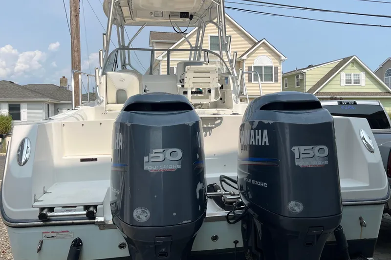 Slide: The Image of 2011 Sailfish 2660 WAC boat with twin Yamaha 150 engines, parked in residential area. - 16