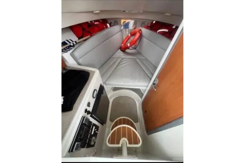 Slide: The Image of 2011 Sailfish 2660 WAC cabin interior with seating, life jackets, and safety equipment. - 7