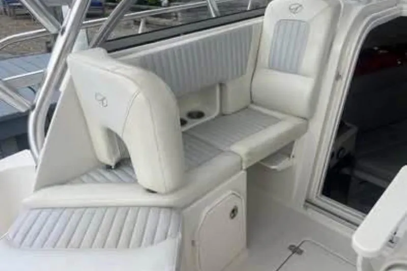 Slide: The Image of 2011 Sailfish 2660 WAC boat interior seating with white upholstery. - 9