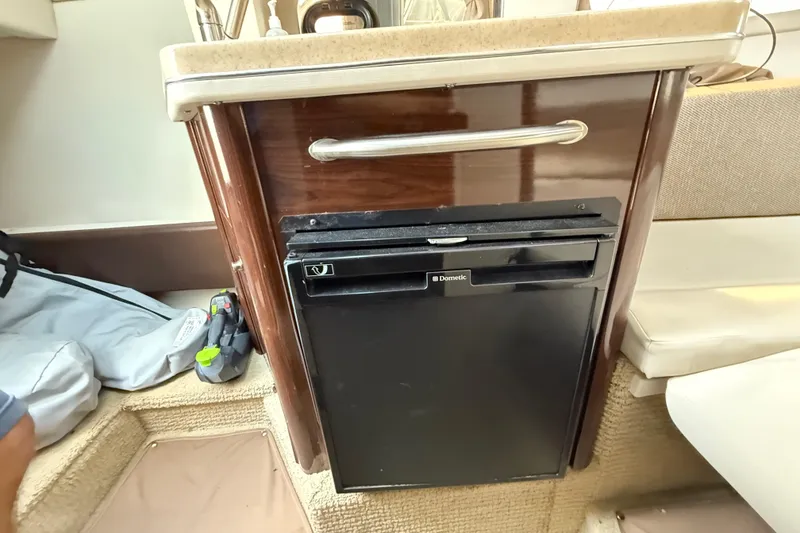 Slide: The Image of Interior of 2015 Sea Ray 260 Sundancer with compact Dometic fridge. - 14