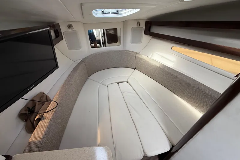 Slide: The Image of Interior of 2015 Sea Ray 260 Sundancer with cozy seating and mounted TV. - 15