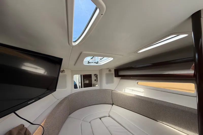 Slide: The Image of Interior of 2015 Sea Ray 260 Sundancer with skylights and a mounted TV. - 18