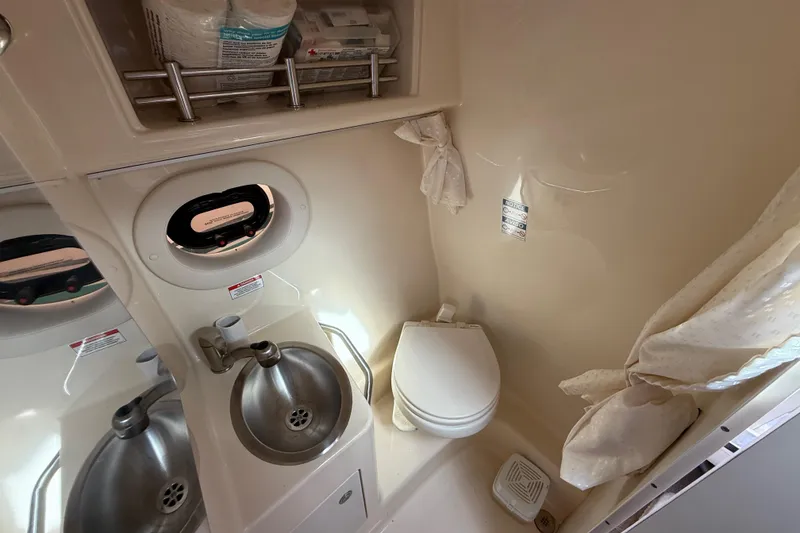 Slide: The Image of Compact bathroom in 2015 Sea Ray 260 Sundancer boat with sink and toilet. - 19