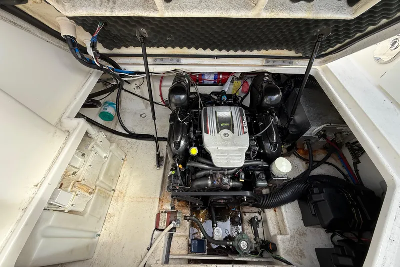 Slide: The Image of Engine compartment of a 2015 Sea Ray 260 Sundancer boat, showcasing mechanical components. - 21