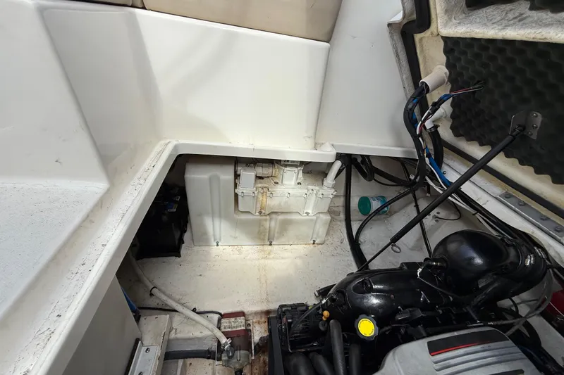 Slide: The Image of Engine compartment of a 2015 Sea Ray 260 Sundancer boat, showing mechanical components and wiring. - 22