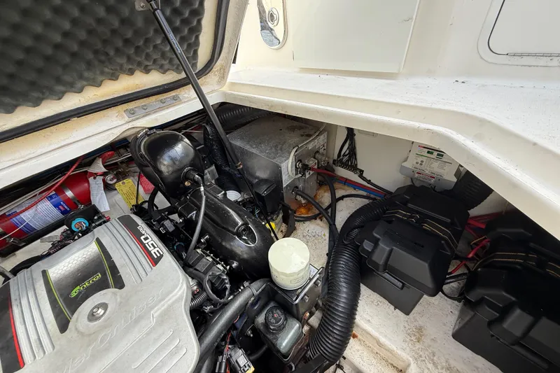 Slide: The Image of Engine compartment of a 2015 Sea Ray 260 Sundancer boat, showing detailed components. - 23